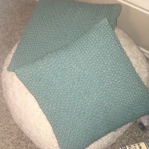 Two teal blue throw pillows